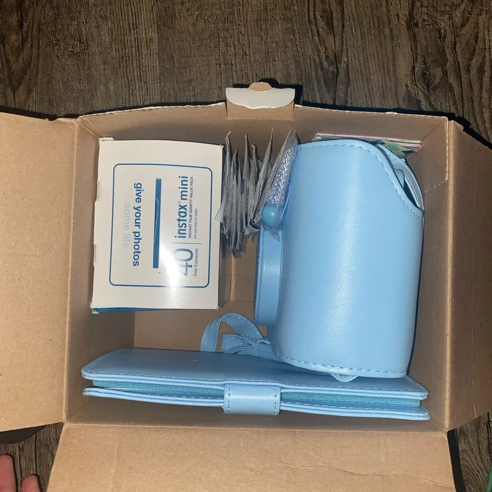 Baby Blue Polaroid Camera with photo book, film, and etc.